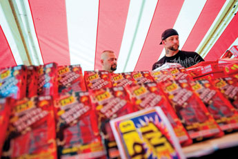 Todd Willmon, right, and Oscar Suarez browse the selection of fireworks at Ellis Tanner Trading Company's TNT Fireworks stand on east N.M. Highway 118 Thursday. © 2011 Gallup Independent / Cable Hoover 